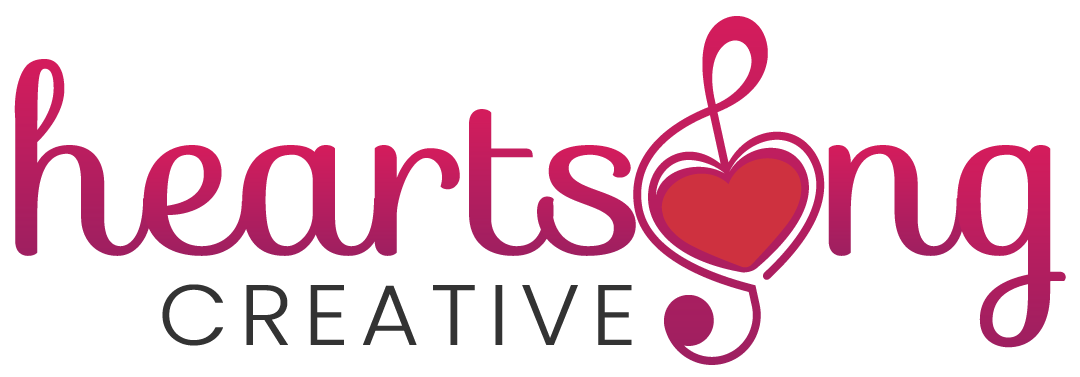 Heartsong Creative logo — script wordmark with treble clef heart